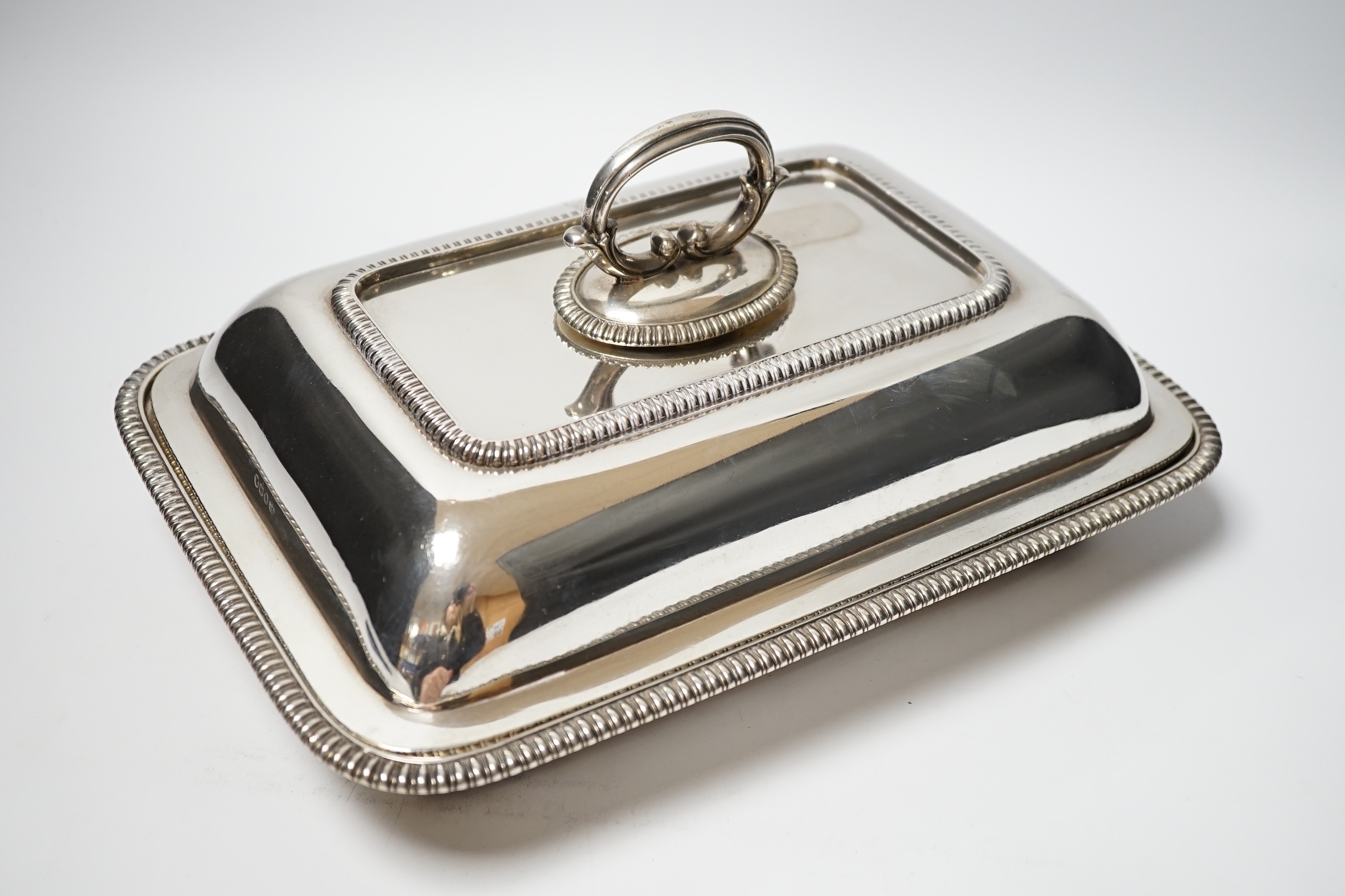 A matched silver entree dish and cover, base Foskett & Stewart, London, 1809, 31.2cm, cover makers mark rubbed, London, 1806, 64.4oz, with a silver plated handle